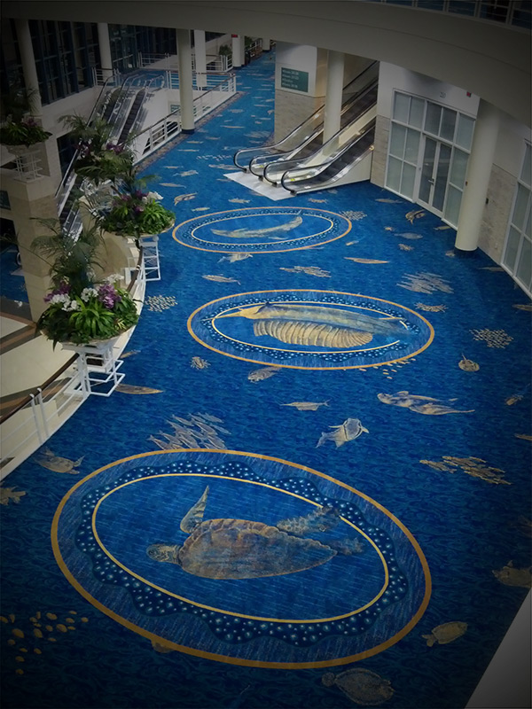 A blue carpet with gold designs in the middle of it.